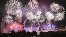 Pink, purple and white fireworks display in London, with the London Eye