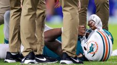 Tua Tagovailoa #1 of the Miami Dolphins lays on the ground after colliding with Damar Hamlin #3 of the Buffalo Bills during the third quarter in the game at Hard Rock Stadium on September 12, 2024