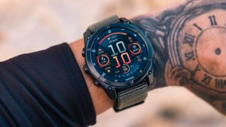 Garmin Fenix 8 watch on wrist of tattooed male