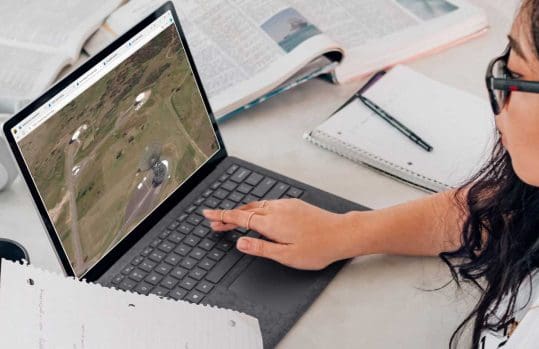 a woman viewing satellite imagery on a laptop