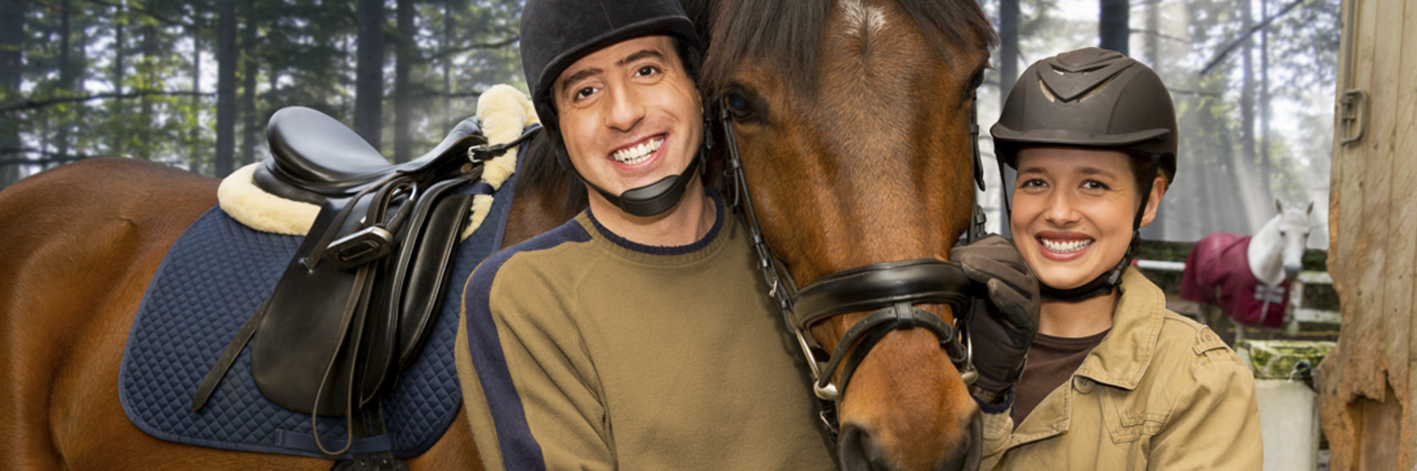 A man and woman stand next to a horse