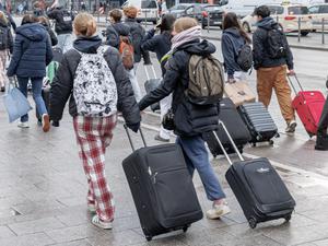 Schüler auf Klassenfahrt in Hamburg gehen mit ihren Koffern vom Hauptbahnhof zu einem Hostel.