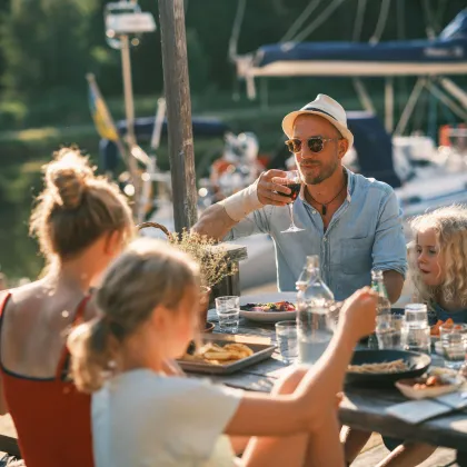 Familj äter lunch på bryggan