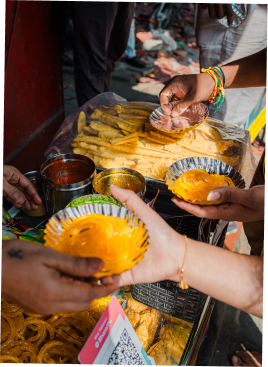 Hands scraping native yellow fruit in India.