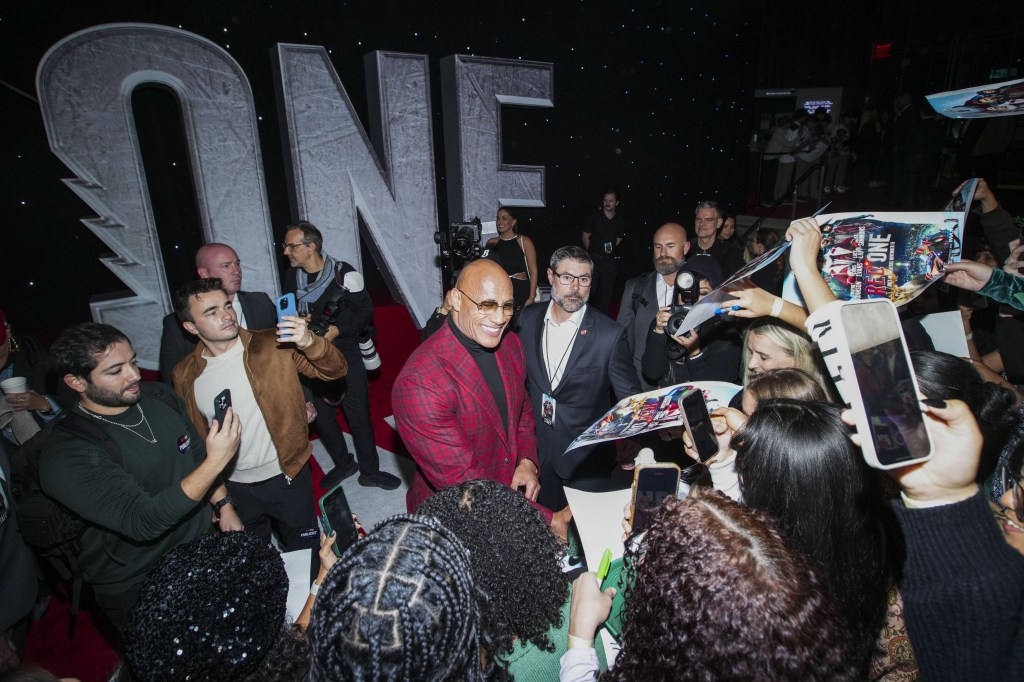 Dwayne Johnson standing in front of a crowd at the AMAZON MGM Studios Red One US Premiere in Alice Tully Hall, New York City on November 11, 2024.