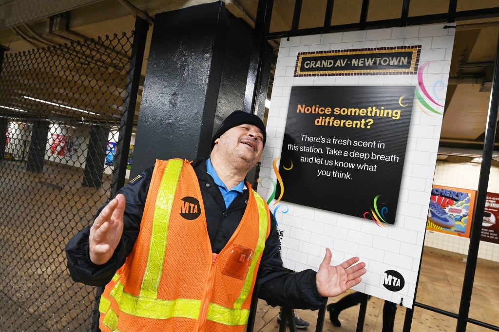 MTA security guard Nelson Victor enjoying the new aroma from a scent diffuser at the Grand Ave.-Newtown subway station in Queens, New York.