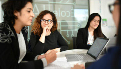 Four female executives in a business meeting.