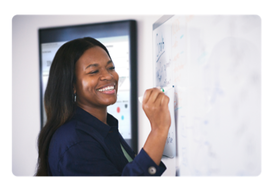 Woman writing on a white board.