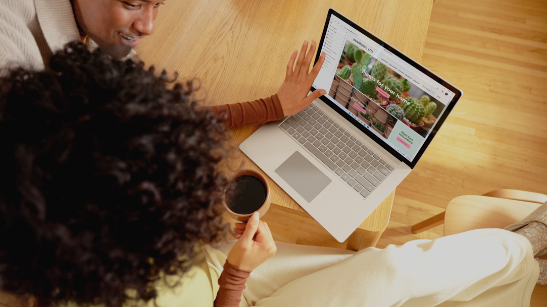 A Woman showing a man something on a Surface device