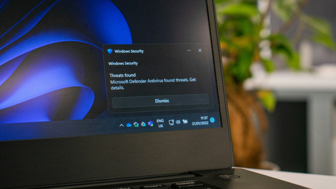 A laptop in dark mode with a Windows Security warning box