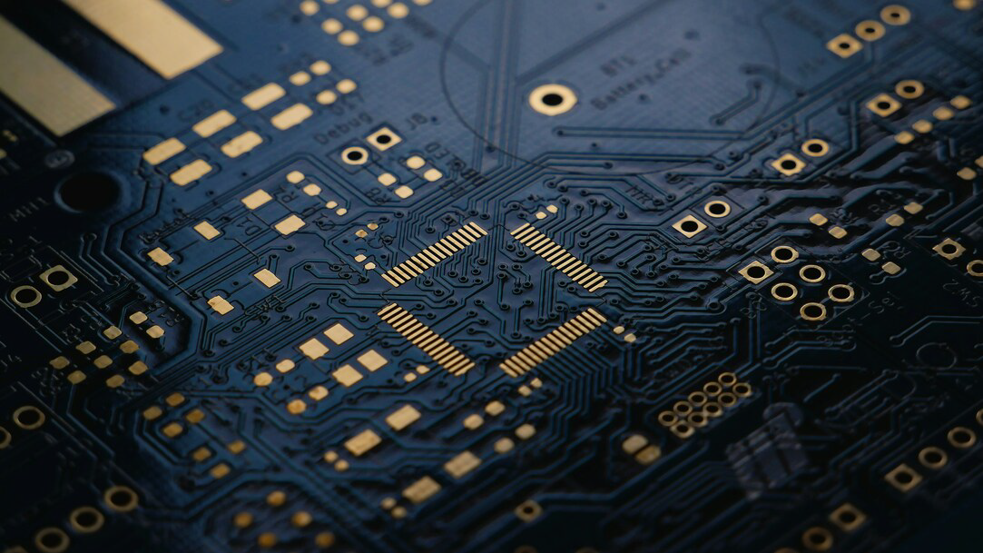 A low exposure photograph of an unsoldered Printed Circuit Board (PCB) with ENIG (Gold) finish