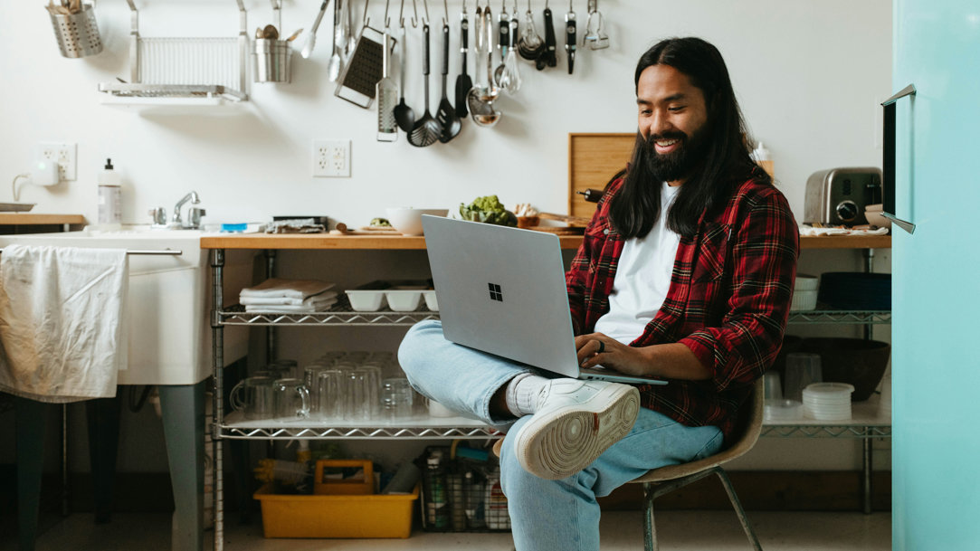 A man using a Surface laptop