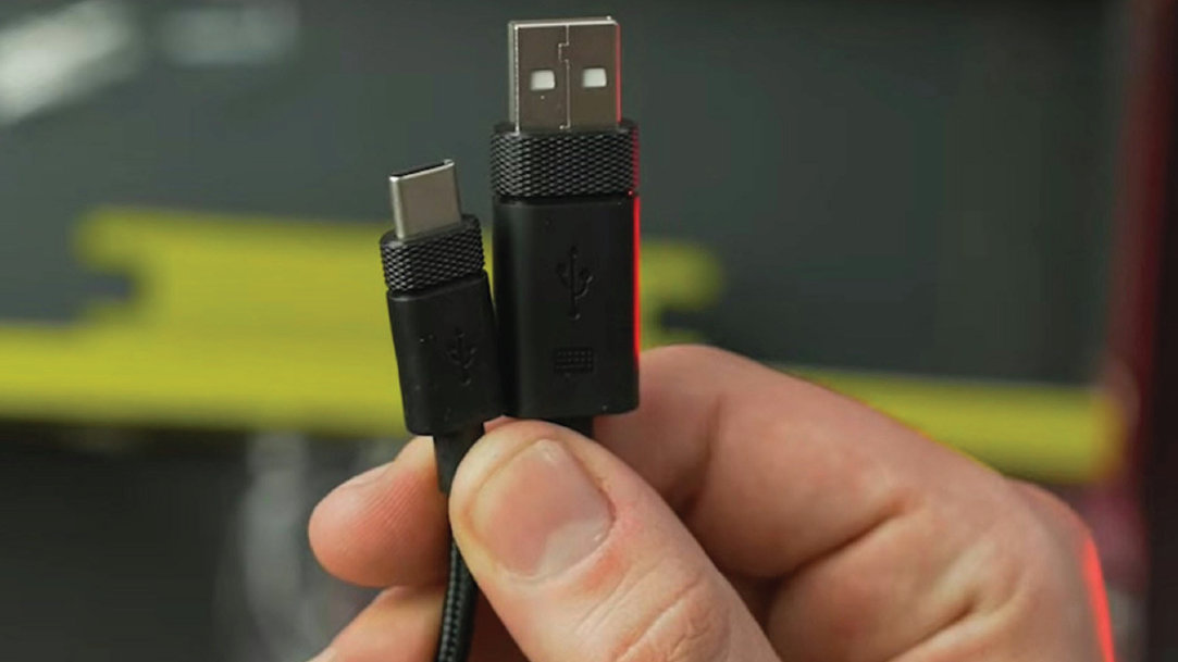 A person holding USB cables