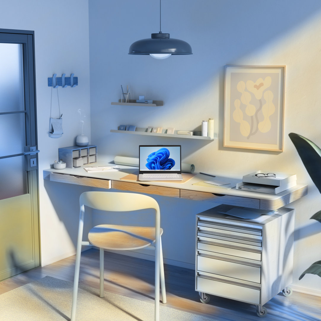 An open laptop sitting on a desk in an office with shelves, drawers, a chair, and hanging light