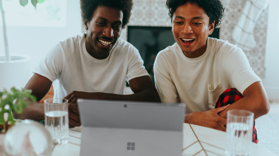 Happy father and son using Surface Pro together