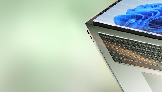 A tilted, partial view of an open Microsoft Windows laptop with the blue bloom screen.