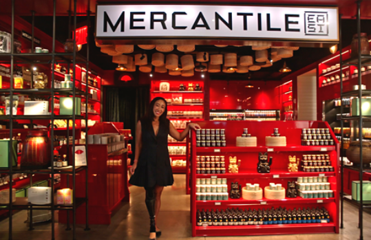 Image of a woman standing in front of her MERCANTILE store