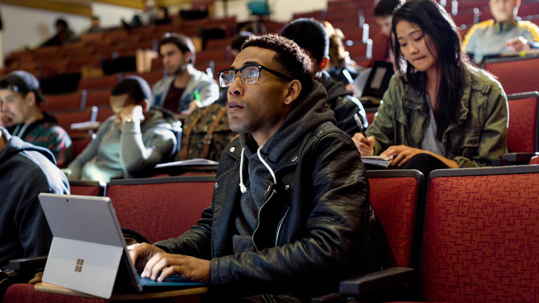 Man in a lecture hall with other students