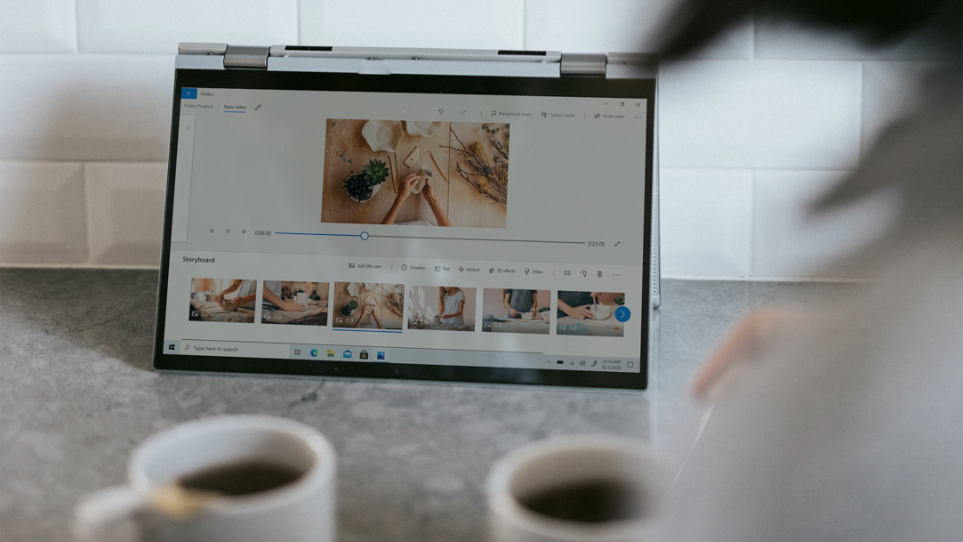 People drinking coffee and viewing photos on a  Windows laptop