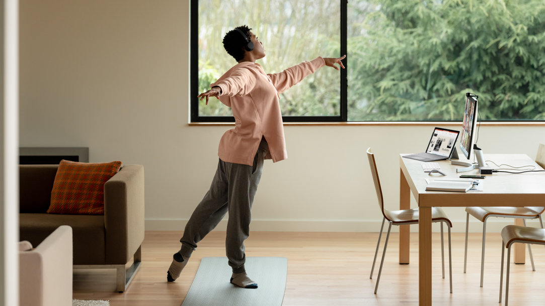 Person doing yoga poses in front of a Surface device