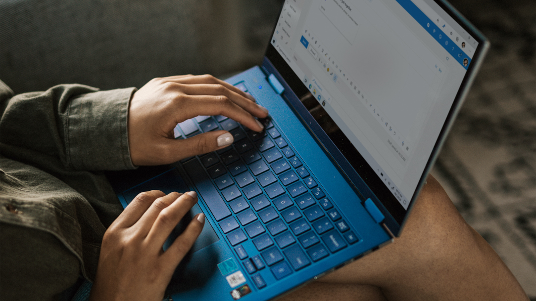 Person sending email on Windows laptop