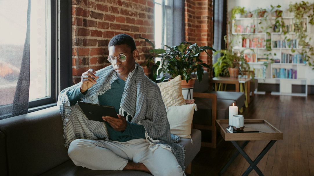 Person sitting on couch using a Surface device