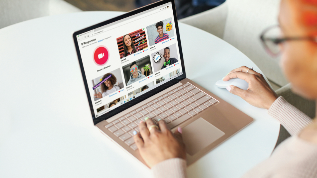 Person using a Surface Laptop on a white desk