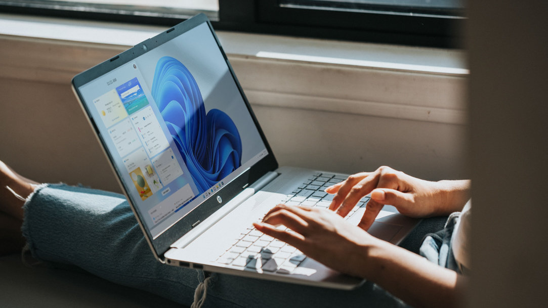 Person using a laptop with a Windows screen