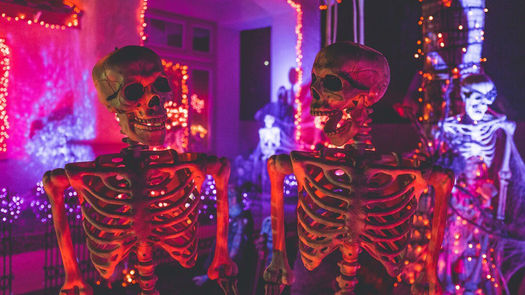 Several skeletons with red stringed lights hung all around the room