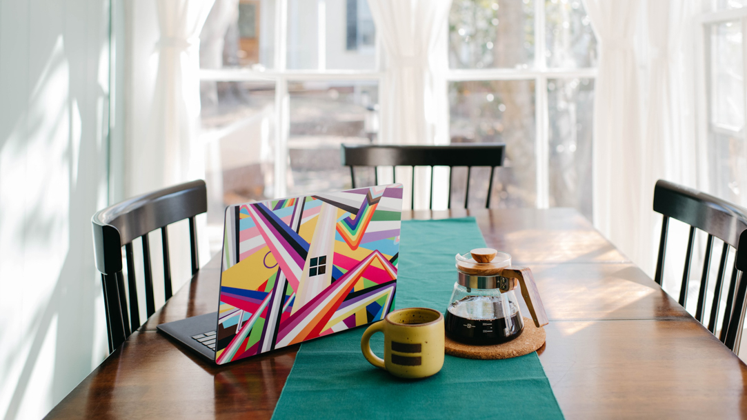 Surface laptop sitting on a kitchen table at home