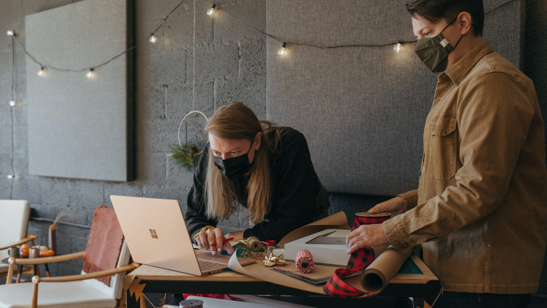 Two people looking at a Surface laptop