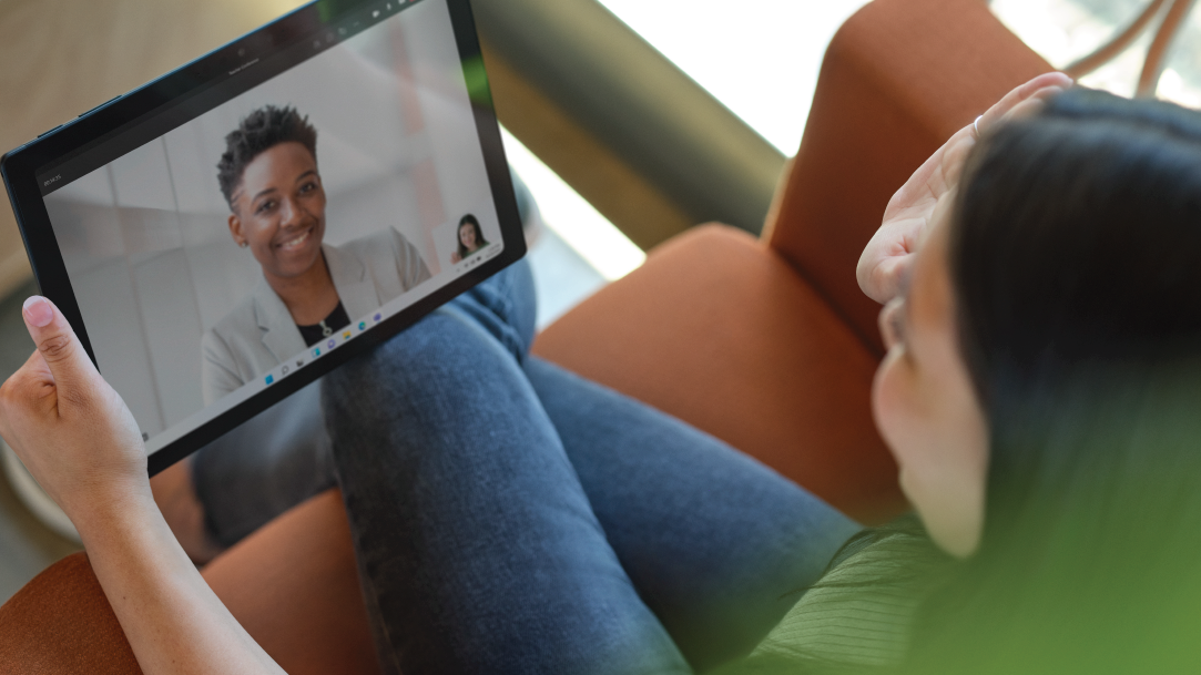 Two people on a video call on a Surface 2-in-1 PC