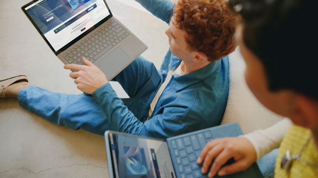 Two young boys on laptops