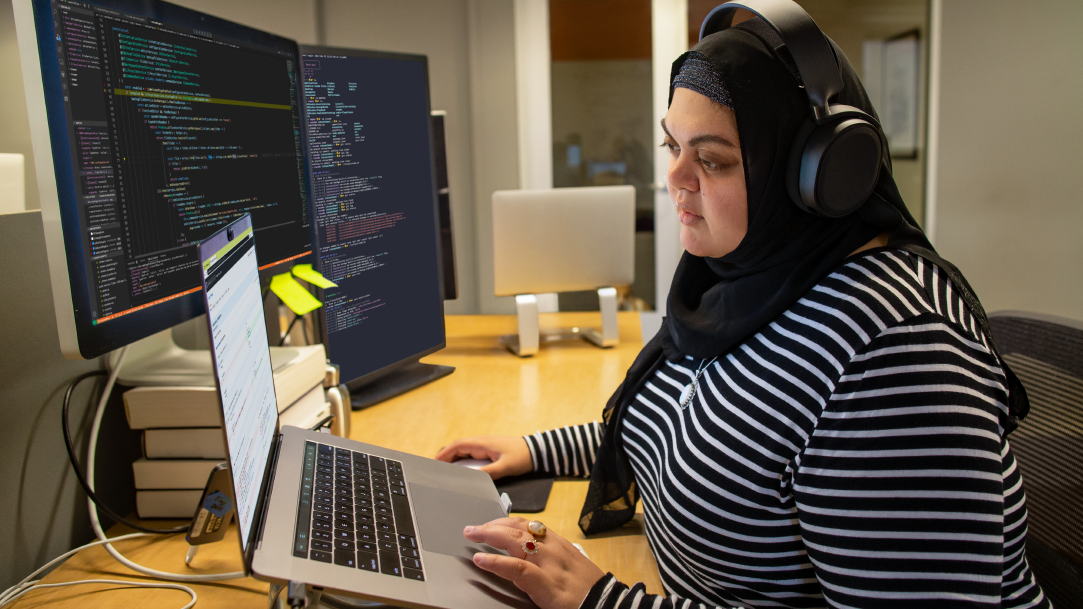 Woman coding on a Surface laptop