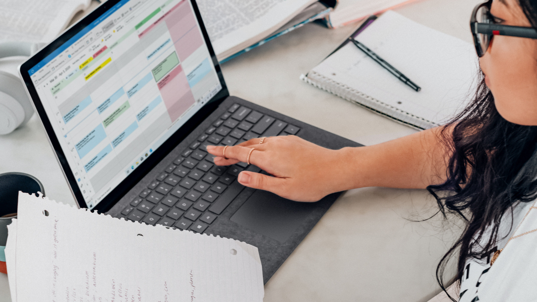 Woman in white shirt using Outlook in Microsoft Edge