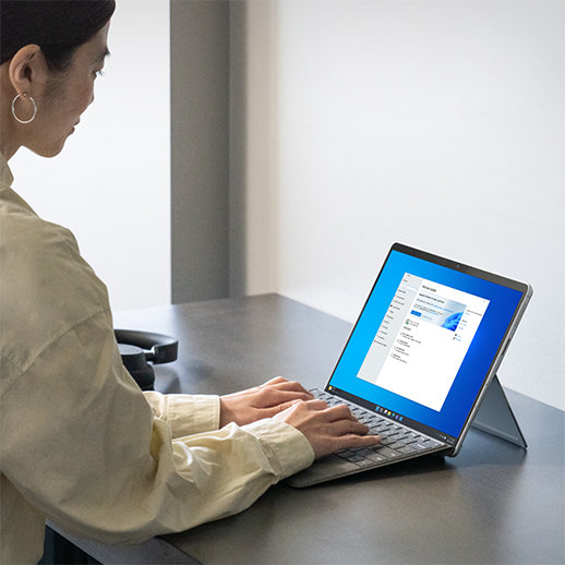 Woman sitting at desk using a Surface device