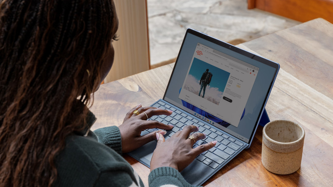 Woman sitting at a table working on her computer