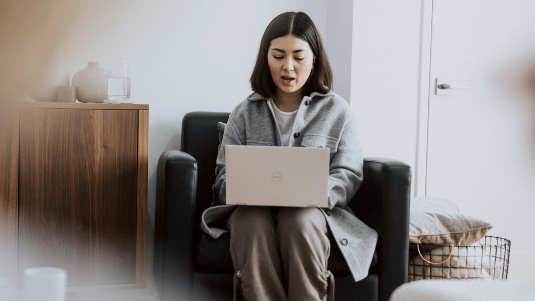 Woman sitting down speaking to her laptop