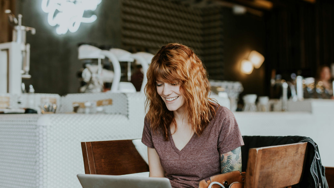 Woman sitting in a café using her computer