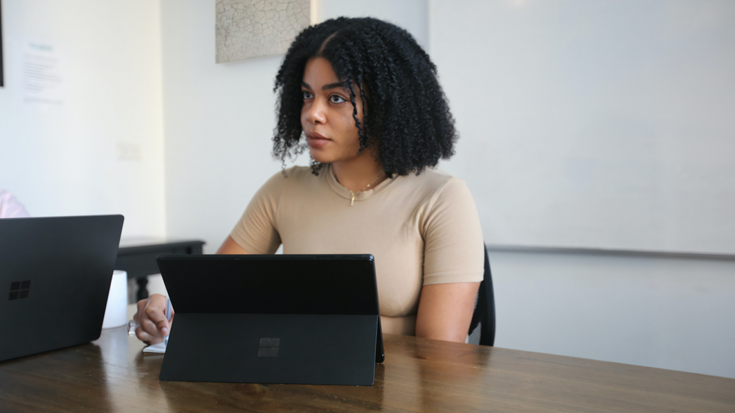 Woman using Surface laptop at table