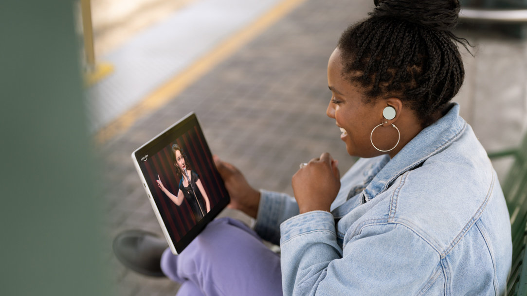 Woman watching a video with Surface Pro 9