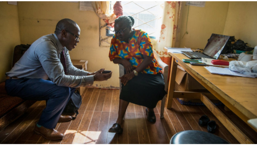 A person demonstrating something on his mobile phone to another person