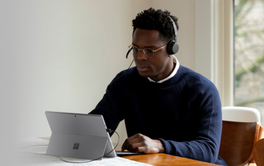 Adult inside using Microsoft Modern USB Headset and Surface Pro