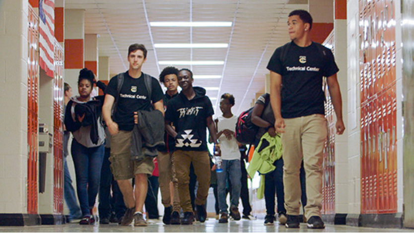 A group of TEALS students walking the halls of their high school.