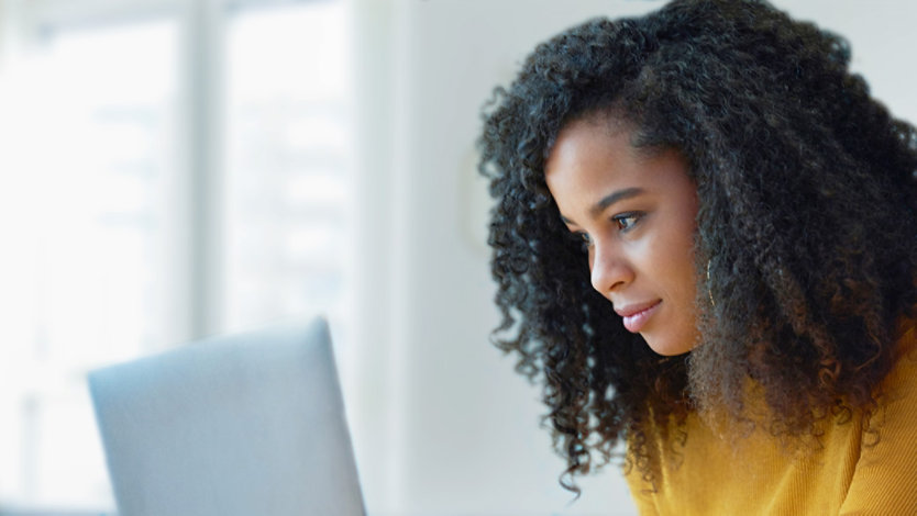 Woman using laptop to edit her resume