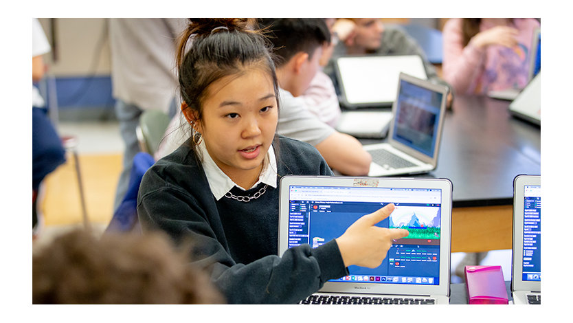 Female student giving a presentation on a computer