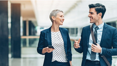 Two businesspersons walking together and talking.