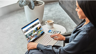 A woman using a Windows 10 laptop with OneDrive