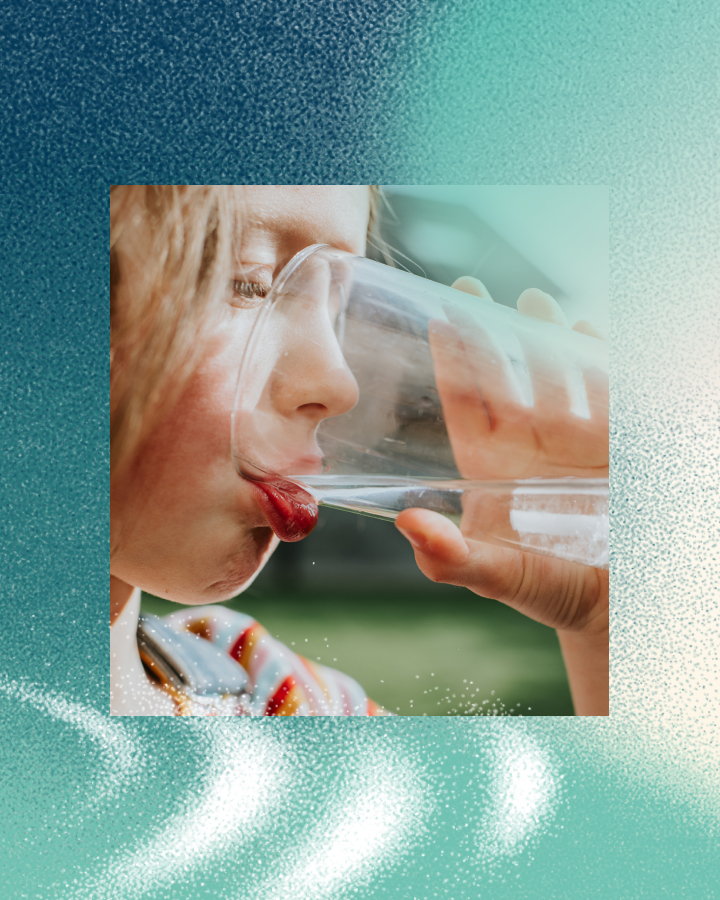 A young woman drinking water from a glass, with a close-up focus on her lips and the glass.