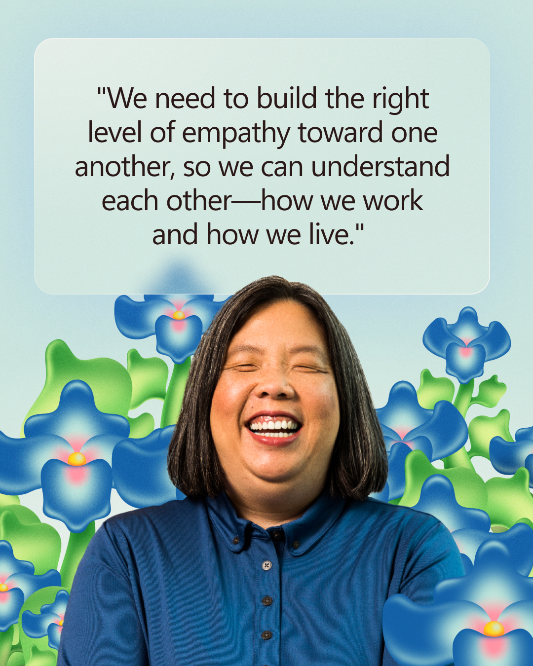 A person smiling in front of a background with blue flowers and a quote about building empathy toward one another.